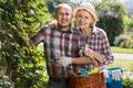 Elderly cheerful couple engaged in gardening