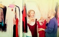 Elderly cheerful woman dressing in changeroom of clothing store Royalty Free Stock Photo