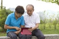 Elderly Chinese couple looking at the mobile tablet Royalty Free Stock Photo