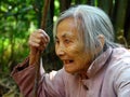 Elderly chinese woman with a staff in her hand