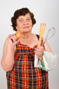 Elderly cook woman showing egg