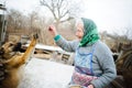 The elderly countrywoman plays with a puppy.