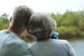 Elderly couple admiring the beauty of summer lake Royalty Free Stock Photo