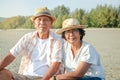 Elderly couple Asians are happy to rest at the sea.