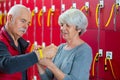 elderly couple attaching locker bracelet around wrist Royalty Free Stock Photo