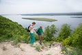 Elderly couple with backpacks travels around mountains. Royalty Free Stock Photo