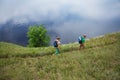 Elderly couple with backpacks travels around mountains. Royalty Free Stock Photo