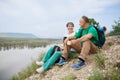 Elderly couple with backpacks travels around mountains. Royalty Free Stock Photo