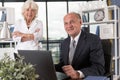 Elderly couple in bureau Royalty Free Stock Photo