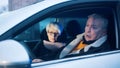 Elderly couple in the car confused with flashing police lights. Speeding ticket Royalty Free Stock Photo