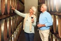 Elderly couple, cellar and glass for wine tasting, retirement and france holiday together. Mature man, woman and romance Royalty Free Stock Photo