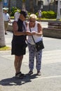 An elderly couple check a till receipt on the the main street of Playa Las Americas in Teneriffe Royalty Free Stock Photo