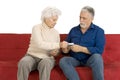 Elderly couple on the couch with money in hand