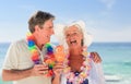 Elderly couple drinking a cocktail on the beach Royalty Free Stock Photo