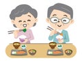 Elderly couple eating with a smile Royalty Free Stock Photo