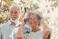 Elderly couple embracing in spring park outdoors having fun and enjoying together looking at the trees. Two old and mature people Royalty Free Stock Photo