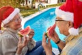 Elderly couple enjoying in watermelon and celebrating  Christmas time Royalty Free Stock Photo