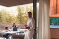 An elderly couple enjoys the terrace of a luxury house with their son during the holidays. Selective focus Royalty Free Stock Photo