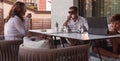 An elderly couple enjoys the terrace of a luxury house with their son during the holidays. Selective focus Royalty Free Stock Photo