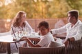 An elderly couple enjoys the terrace of a luxury house with their son during the holidays. Selective focus Royalty Free Stock Photo