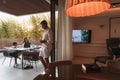 An elderly couple enjoys the terrace of a luxury house with their son during the holidays. Selective focus Royalty Free Stock Photo