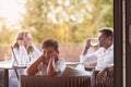 An elderly couple enjoys the terrace of a luxury house with their son during the holidays. Selective focus Royalty Free Stock Photo