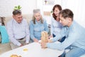 Elderly couple with family Closeup making a pyramid with empty wooden cubes close up