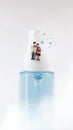 Elderly couple figure sitting on a alcohol spray bottle. Covid-19 concept