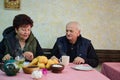 Elderly couple finds pure joy in the serene morning as they savor a cup of coffee, immersed in the tranquil beauty of