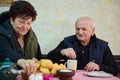 Elderly couple finds pure joy in the serene morning as they savor a cup of coffee, immersed in the tranquil beauty of