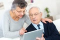 Elderly couple in front tablet Royalty Free Stock Photo