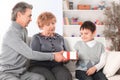 Elderly couple gives a gift to their grandson on his birthday Royalty Free Stock Photo