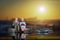 Elderly Couple Golden Age Inflation Pensions Sitting Coin Pile Sunset Miniature People Figures