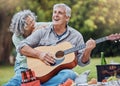 Elderly, couple and guitar at happy picnic in garden, park or nature together. Man, woman and music for happiness on Royalty Free Stock Photo