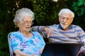 Elderly couple having fun with the laptop outdoors Royalty Free Stock Photo