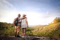 An old married couple standing on a happy high mountain