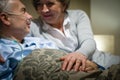 Elderly couple holding hands lying in bed Royalty Free Stock Photo