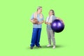 Elderly couple holds basketball and pilates ball Royalty Free Stock Photo