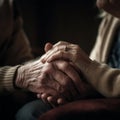 An elderly couple holds each other& x27;s hands. family, love and support