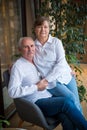 Elderly couple is hugging on a armchair Royalty Free Stock Photo