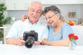 Elderly couple looking at photos on display digital camera Royalty Free Stock Photo