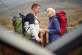 An elderly couple in love chatting and enjoying the view on the top of a watchtower in the forest