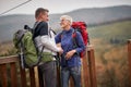 An elderly couple in love enjoying lovely moments on the top of a watchtower in the forest