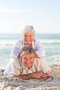 Elderly couple lying down on the beach Royalty Free Stock Photo