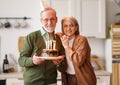 Elderly couple man and woman with cake celebrating birthday and anniversary Royalty Free Stock Photo