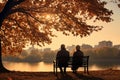 an elderly couple, a man and a woman, are sitting on a bench and enjoying the scenery, beautiful landscape at sunset, rear view Royalty Free Stock Photo