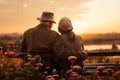 an elderly couple, a man and a woman, are sitting on a bench and enjoying the scenery, rear view Royalty Free Stock Photo