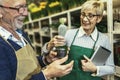 Couple in own flower shop. Concept of small business Royalty Free Stock Photo