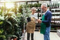 Senior couple in own flower shop. Concept of small business Royalty Free Stock Photo