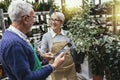 Senior couple in own flower shop. Concept of small business Royalty Free Stock Photo